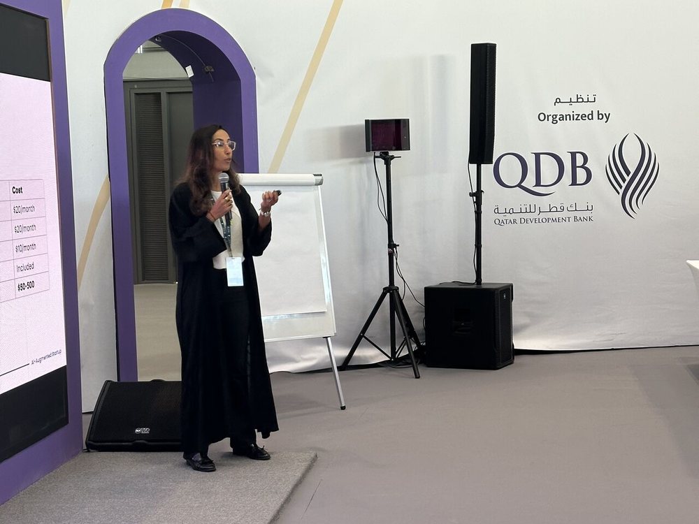 Karima Rahali-Sebti presenting on stage at Rowad 2025 in Doha, organised by Qatar Development Bank